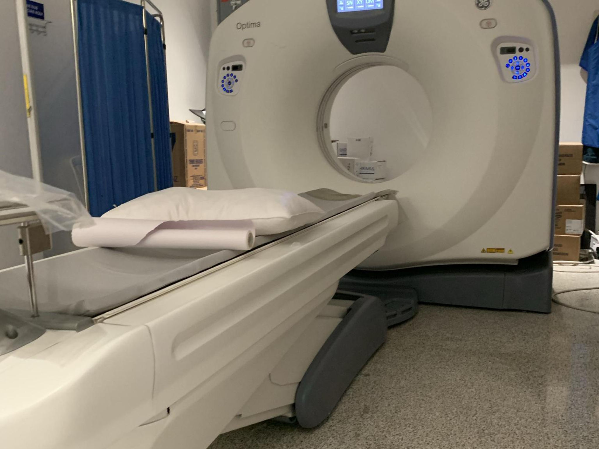 CT scanner and patient table in a clinical room for buyer evaluation.
